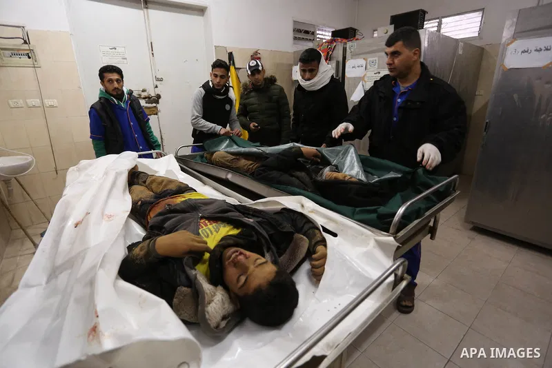 The relatives of two Palestinians killed in an Israeli air strike, bid them farewell at a morgue of a hospital in Rafah in the southern Gaza Strip on late February 18, 2018. Two Palestinians were killed by Israeli fire,...