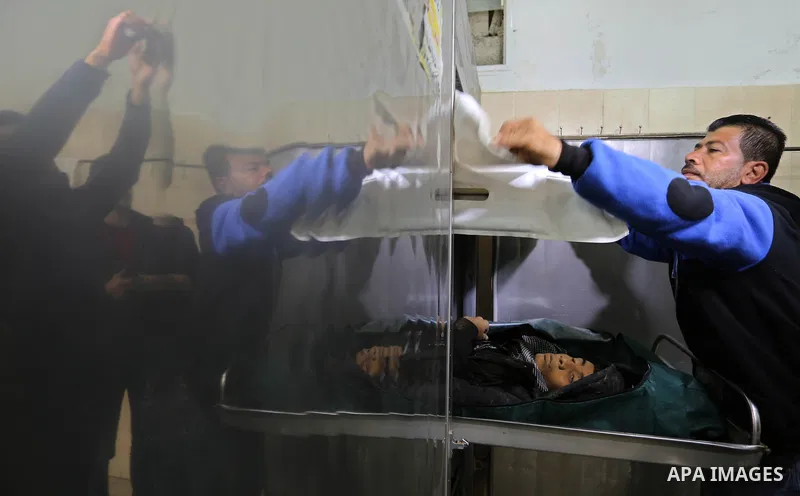 The relatives of two Palestinians killed in an Israeli air strike, bid them farewell at a morgue of a hospital in Rafah in the southern Gaza Strip on late February 18, 2018. Two Palestinians were killed by Israeli fire,...