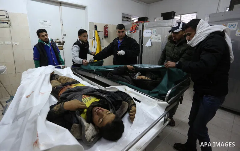 The relatives of two Palestinians killed in an Israeli air strike, bid them farewell at a morgue of a hospital in Rafah in the southern Gaza Strip on late February 18, 2018. Two Palestinians were killed by Israeli fire,...