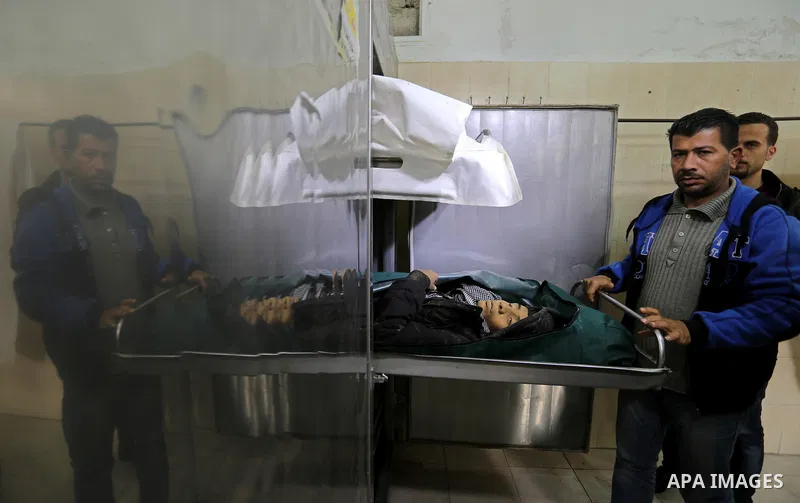 The relatives of two Palestinians killed in an Israeli air strike, bid them farewell at a morgue of a hospital in Rafah in the southern Gaza Strip on late February 18, 2018. Two Palestinians were killed by Israeli fire,...