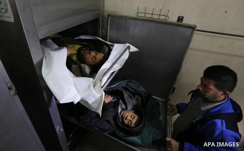 The relatives of two Palestinians killed in an Israeli air strike, bid them farewell at a morgue of a hospital in Rafah in the southern Gaza Strip on late February 18, 2018. Two Palestinians were killed by Israeli fire,...