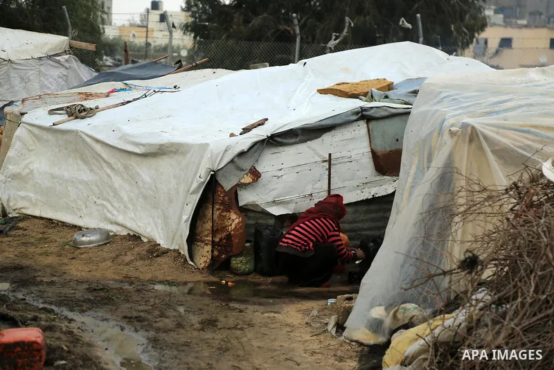 A Palestinian woman washes a tea pot outside of her family house in an impoverished area in Gaza City on February 18, 2018. Photo by Dawoud Abo Alkas