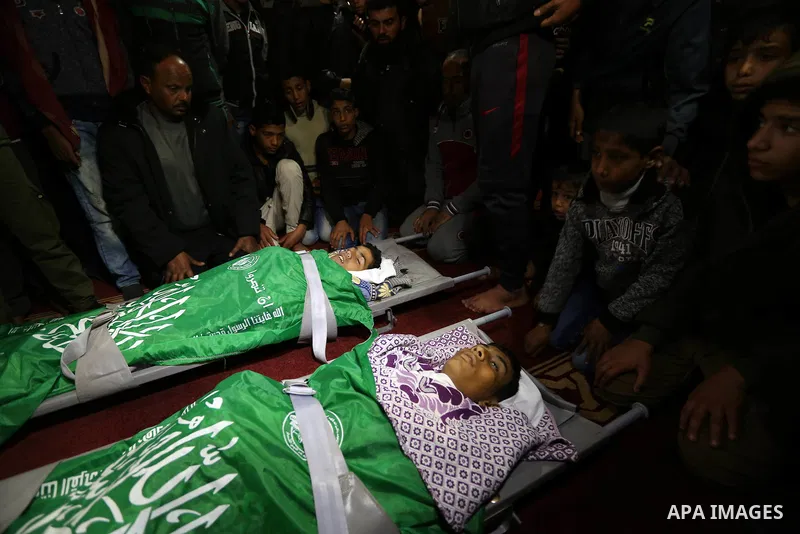Relatives mourn over the bodies of two Palestinian teenagers, who were killed following Israeli air strikes, during their funeral, in Rafah in the southern Gaza Strip on February 18, 2018. Two Palestinians were killed by...