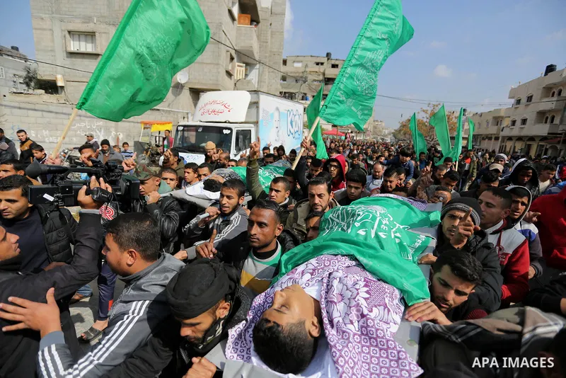 Mourners carry the bodies of two Palestinian teenagers, who were killed following Israeli air strikes, during their funeral, in Rafah in the southern Gaza Strip on February 18, 2018. Two Palestinians were killed by Israe...