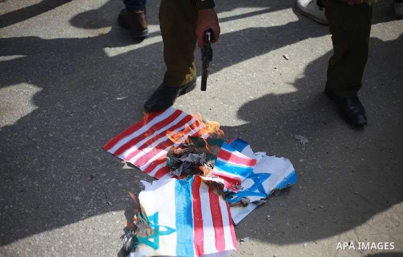A Palestinian demonstrator burns an Israeli, British and U.S. flags during a protest to show solidarity with Palestinian prisoners held in Israeli jails, in front of Red cross office in Gaza city on February 19, 2018. Ph...
