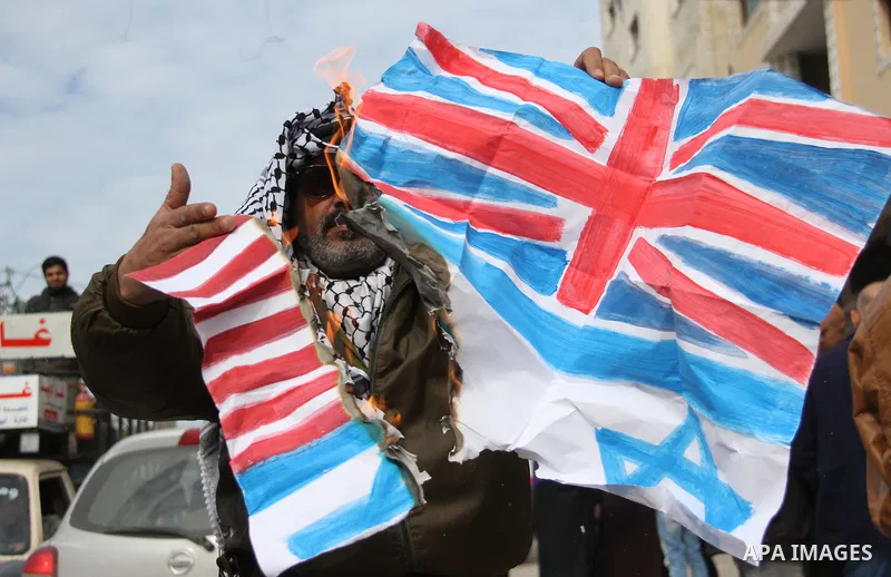 A Palestinian demonstrator burns an Israeli, British and U.S. flags during a protest to show solidarity with Palestinian prisoners held in Israeli jails, in front of Red cross office in Gaza city on February 19, 2018. Ph...