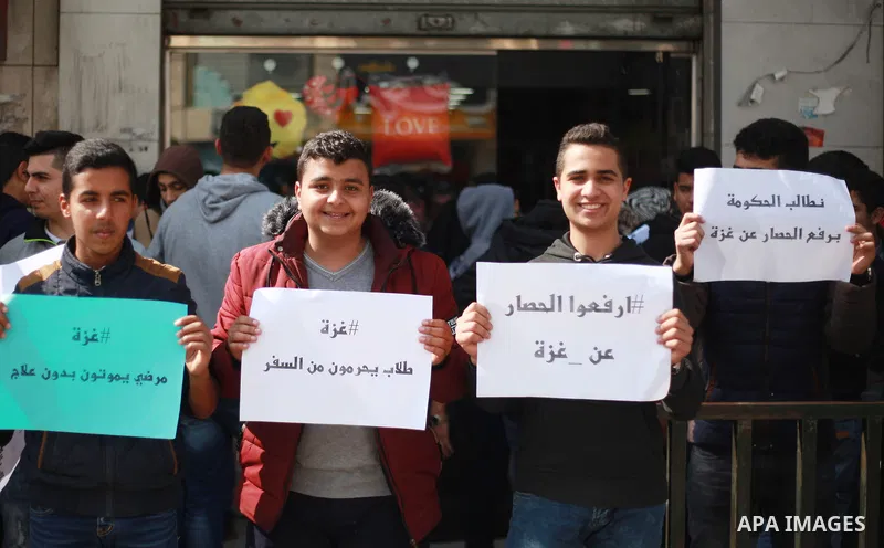 Palestinian employees of Gaza strip hold banners during a demonstration demanding their salaries in Gaza city on February 19, 2018. Photo by Mahmoud Ajour