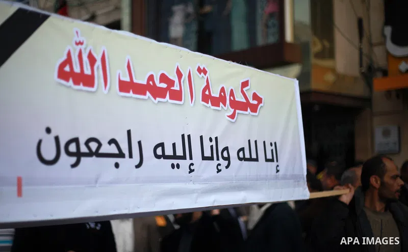 Palestinian employees of Gaza strip hold banners during a demonstration demanding their salaries in Gaza city on February 19, 2018. Photo by Mahmoud Ajour