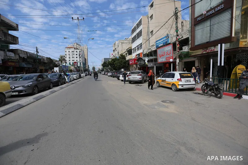 Palestinians walk at street in Gaza City on February 20, 2018 during a traffic jam caused by a general strike to protest the humanitarian situation in Gaza. Photo by Ashraf Amra