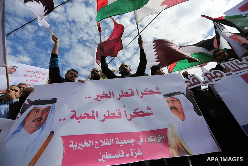 Palestinians hold Qatari flags and banners in a rally to say "Thank" to Qatar to provide a nine million dollar humanitarian relief grant to residents of the Gaza Strip, in Gaza city on February 20, 2018. Photo by Ashraf...