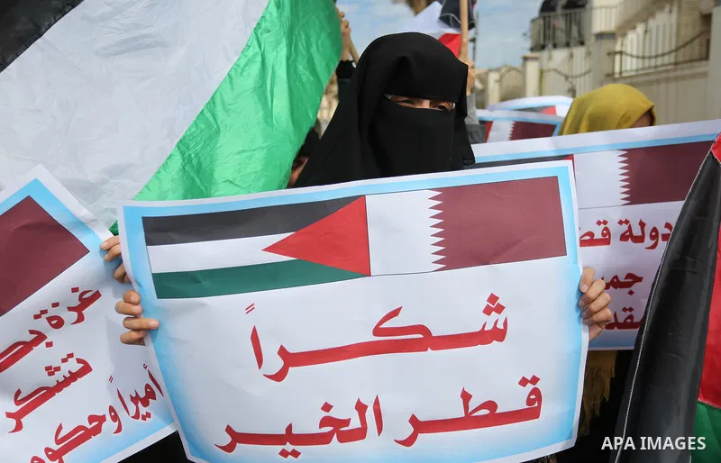 Palestinians hold Qatari flags and banners in a rally to say "Thank" to Qatar to provide a nine million dollar humanitarian relief grant to residents of the Gaza Strip, in Gaza city on February 20, 2018. Photo by Ashraf...