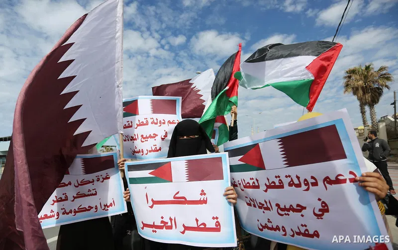 Palestinians hold Qatari flags and banners in a rally to say "Thank" to Qatar to provide a nine million dollar humanitarian relief grant to residents of the Gaza Strip, in Gaza city on February 20, 2018. Photo by Ashraf...