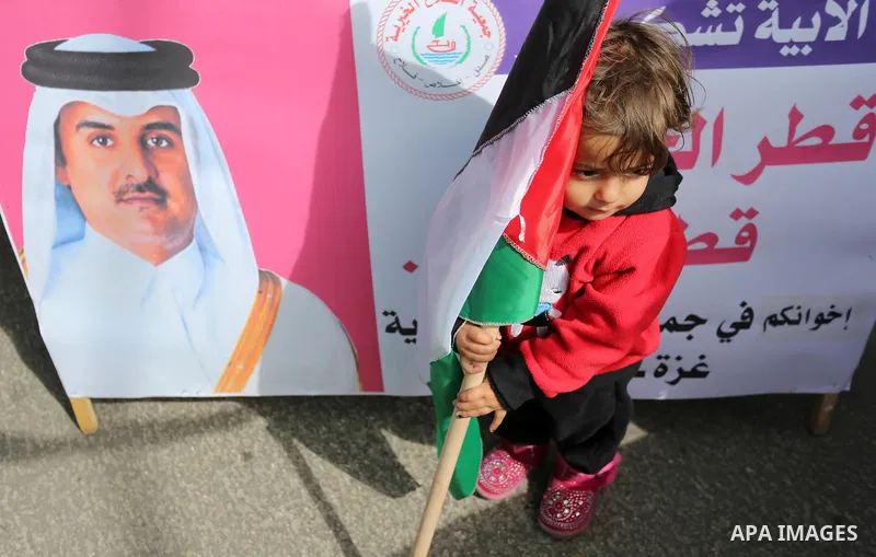 Palestinians hold Qatari flags and banners in a rally to say "Thank" to Qatar to provide a nine million dollar humanitarian relief grant to residents of the Gaza Strip, in Gaza city on February 20, 2018. Photo by Ashraf...