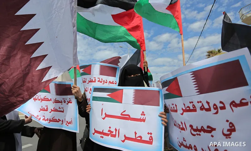 Palestinians hold Qatari flags and banners in a rally to say "Thank" to Qatar to provide a nine million dollar humanitarian relief grant to residents of the Gaza Strip, in Gaza city on February 20, 2018. Photo by Ashraf...