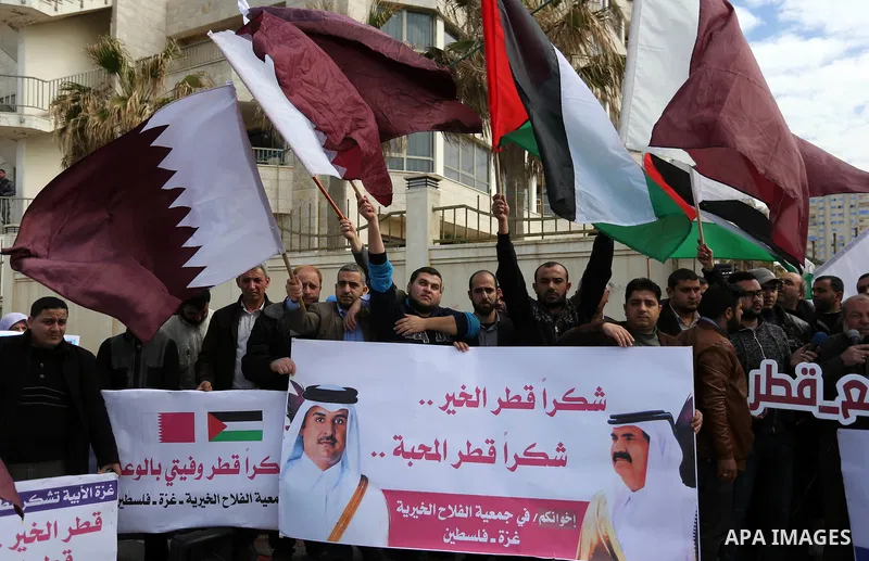 Palestinians hold Qatari flags and banners in a rally to say "Thank" to Qatar to provide a nine million dollar humanitarian relief grant to residents of the Gaza Strip, in Gaza city on February 20, 2018. Photo by Ashraf...