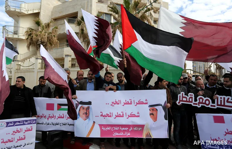 Palestinians hold Qatari flags and banners in a rally to say "Thank" to Qatar to provide a nine million dollar humanitarian relief grant to residents of the Gaza Strip, in Gaza city on February 20, 2018. Photo by Ashraf...