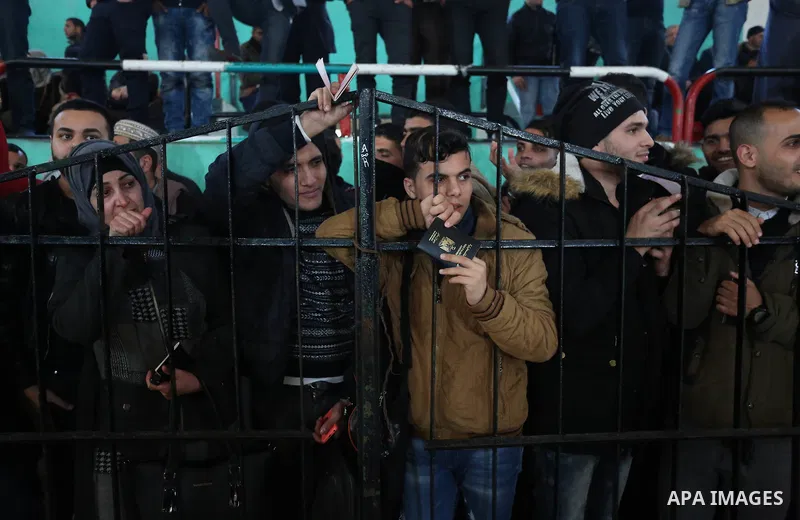 Palestinians wait for permission to cross into Egypt through the Rafah border crossing in the southern Gaza Strip after it was opened by Egyptian authorities on February 21, 2018. Both Israel and Egypt have maintained bl...