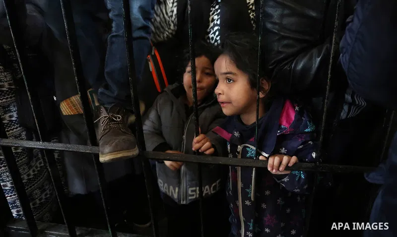 Palestinians wait for permission to cross into Egypt through the Rafah border crossing in the southern Gaza Strip after it was opened by Egyptian authorities on February 21, 2018. Both Israel and Egypt have maintained bl...
