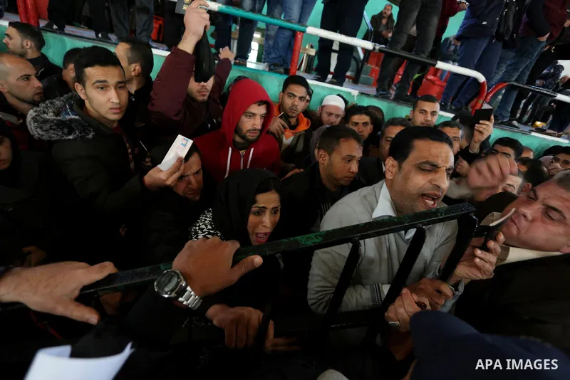 Palestinians wait for permission to cross into Egypt through the Rafah border crossing in the southern Gaza Strip after it was opened by Egyptian authorities on February 21, 2018. Both Israel and Egypt have maintained bl...