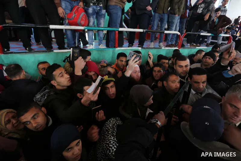 Palestinians wait for permission to cross into Egypt through the Rafah border crossing in the southern Gaza Strip after it was opened by Egyptian authorities on February 21, 2018. Both Israel and Egypt have maintained bl...