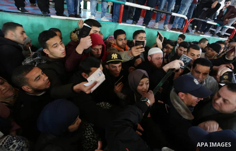 Palestinians wait for permission to cross into Egypt through the Rafah border crossing in the southern Gaza Strip after it was opened by Egyptian authorities on February 21, 2018. Both Israel and Egypt have maintained bl...