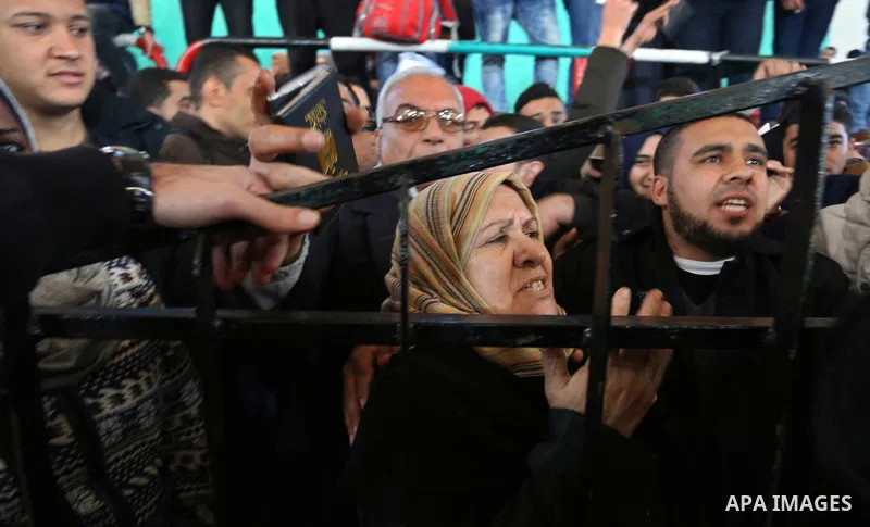 Palestinians wait for permission to cross into Egypt through the Rafah border crossing in the southern Gaza Strip after it was opened by Egyptian authorities on February 21, 2018. Both Israel and Egypt have maintained bl...