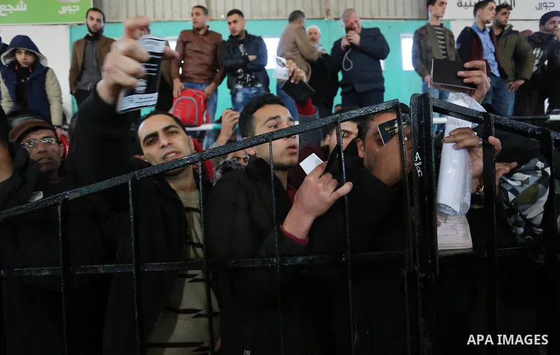 Palestinians wait for permission to cross into Egypt through the Rafah border crossing in the southern Gaza Strip after it was opened by Egyptian authorities on February 21, 2018. Both Israel and Egypt have maintained bl...