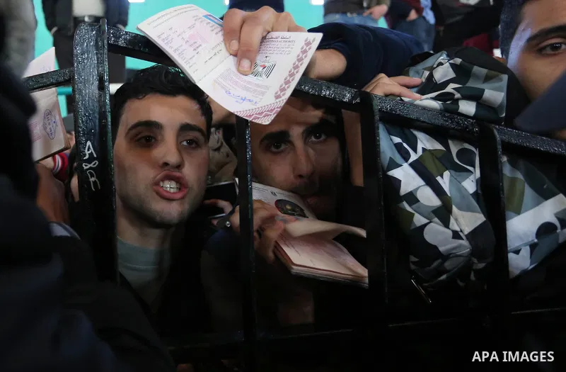 Palestinians wait for permission to cross into Egypt through the Rafah border crossing in the southern Gaza Strip after it was opened by Egyptian authorities on February 21, 2018. Both Israel and Egypt have maintained bl...