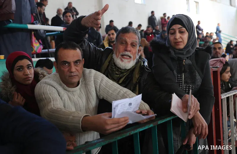 Palestinians wait for permission to cross into Egypt through the Rafah border crossing in the southern Gaza Strip after it was opened by Egyptian authorities on February 21, 2018. Both Israel and Egypt have maintained bl...