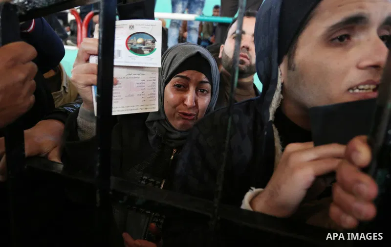 Palestinians wait for permission to cross into Egypt through the Rafah border crossing in the southern Gaza Strip after it was opened by Egyptian authorities on February 21, 2018. Both Israel and Egypt have maintained bl...