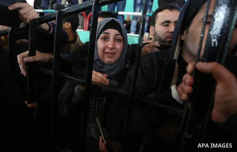 Palestinians wait for permission to cross into Egypt through the Rafah border crossing in the southern Gaza Strip after it was opened by Egyptian authorities on February 21, 2018. Both Israel and Egypt have maintained bl...