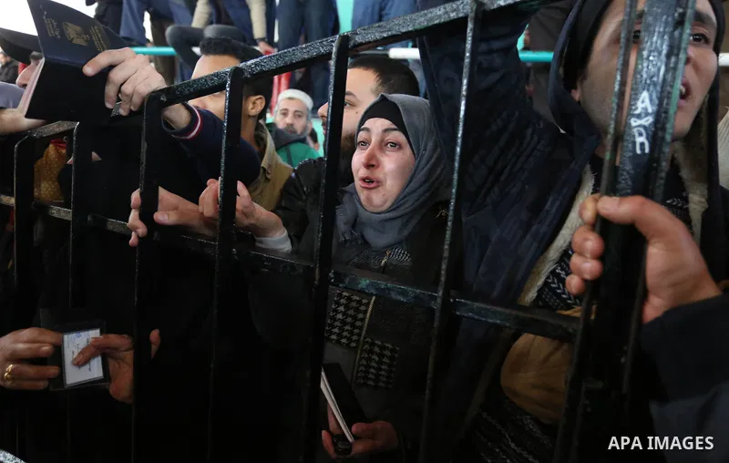 Palestinians wait for permission to cross into Egypt through the Rafah border crossing in the southern Gaza Strip after it was opened by Egyptian authorities on February 21, 2018. Both Israel and Egypt have maintained bl...