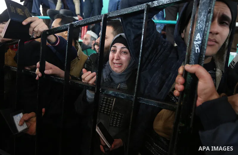 Palestinians wait for permission to cross into Egypt through the Rafah border crossing in the southern Gaza Strip after it was opened by Egyptian authorities on February 21, 2018. Both Israel and Egypt have maintained bl...