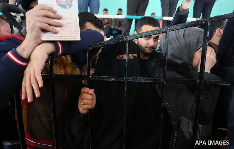 Palestinians wait for permission to cross into Egypt through the Rafah border crossing in the southern Gaza Strip after it was opened by Egyptian authorities on February 21, 2018. Both Israel and Egypt have maintained bl...