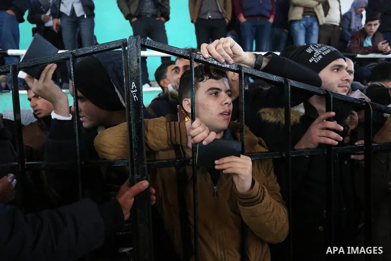 Palestinians wait for permission to cross into Egypt through the Rafah border crossing in the southern Gaza Strip after it was opened by Egyptian authorities on February 21, 2018. Both Israel and Egypt have maintained bl...
