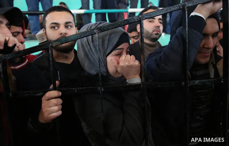 Palestinians wait for permission to cross into Egypt through the Rafah border crossing in the southern Gaza Strip after it was opened by Egyptian authorities on February 21, 2018. Both Israel and Egypt have maintained bl...