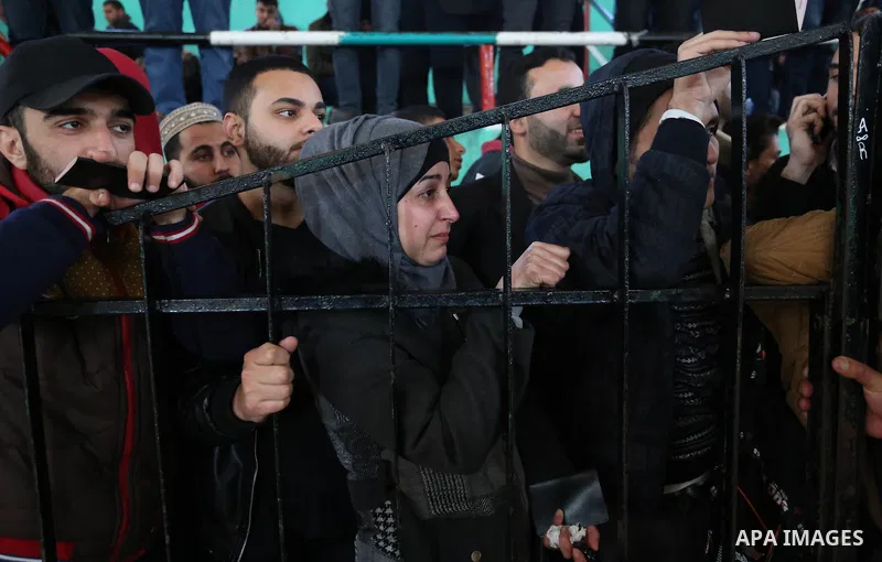 Palestinians wait for permission to cross into Egypt through the Rafah border crossing in the southern Gaza Strip after it was opened by Egyptian authorities on February 21, 2018. Both Israel and Egypt have maintained bl...