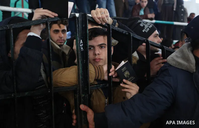 Palestinians wait for permission to cross into Egypt through the Rafah border crossing in the southern Gaza Strip after it was opened by Egyptian authorities on February 21, 2018. Both Israel and Egypt have maintained bl...