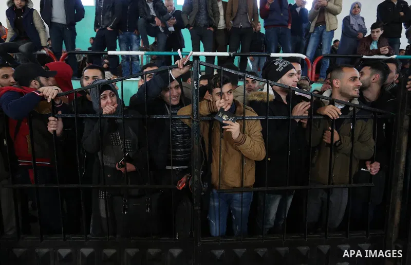 Palestinians wait for permission to cross into Egypt through the Rafah border crossing in the southern Gaza Strip after it was opened by Egyptian authorities on February 21, 2018. Both Israel and Egypt have maintained bl...