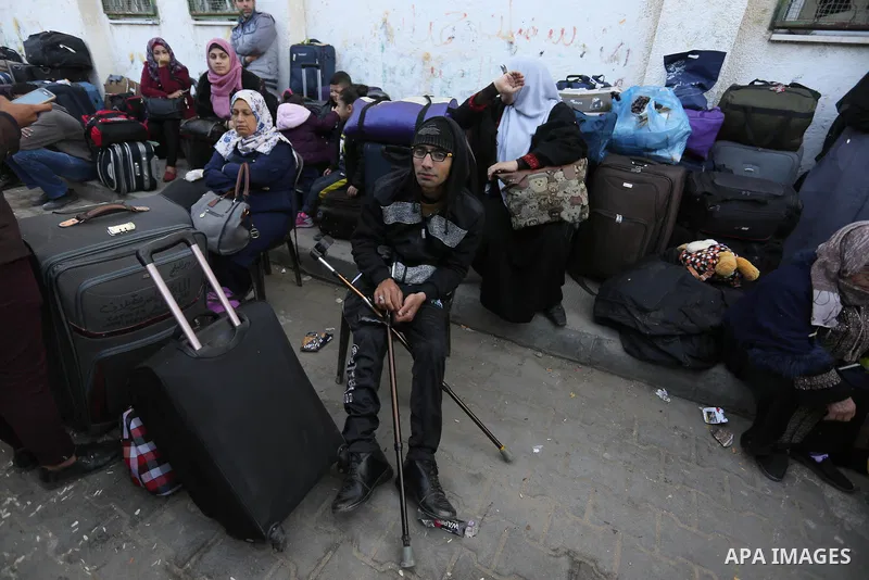 Palestinians wait for permission to cross into Egypt through the Rafah border crossing in the southern Gaza Strip after it was opened by Egyptian authorities on February 21, 2018. Both Israel and Egypt have maintained bl...