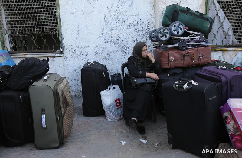 Palestinians wait for permission to cross into Egypt through the Rafah border crossing in the southern Gaza Strip after it was opened by Egyptian authorities on February 21, 2018. Both Israel and Egypt have maintained bl...