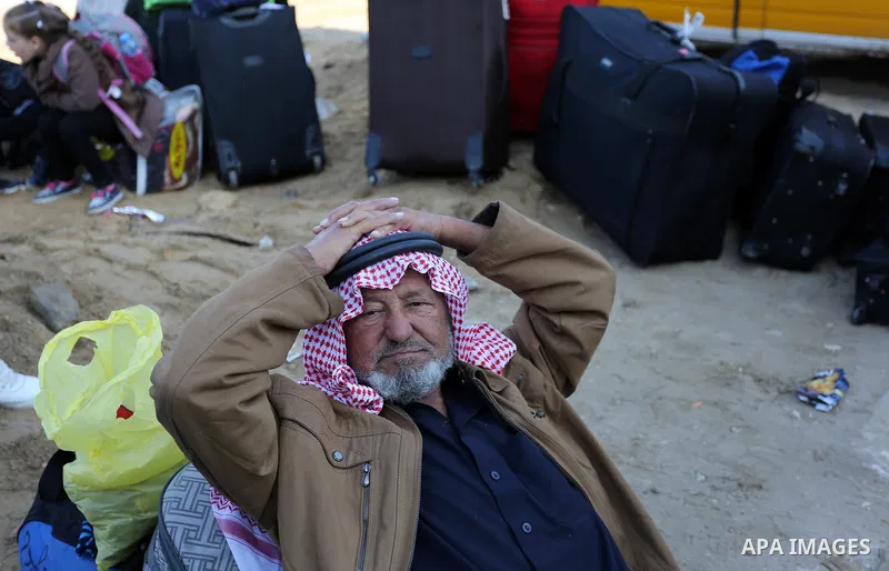 Palestinians wait for permission to cross into Egypt through the Rafah border crossing in the southern Gaza Strip after it was opened by Egyptian authorities on February 21, 2018. Both Israel and Egypt have maintained bl...
