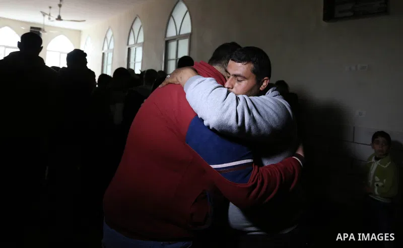 Palestinian relatives of Ahmed Ebu Helou, 19, who died of his injuries after Israeli security forces shot him during clashes against US decision to recognize Jerusalem as Israel's capital, mourn during his funeral, in al...