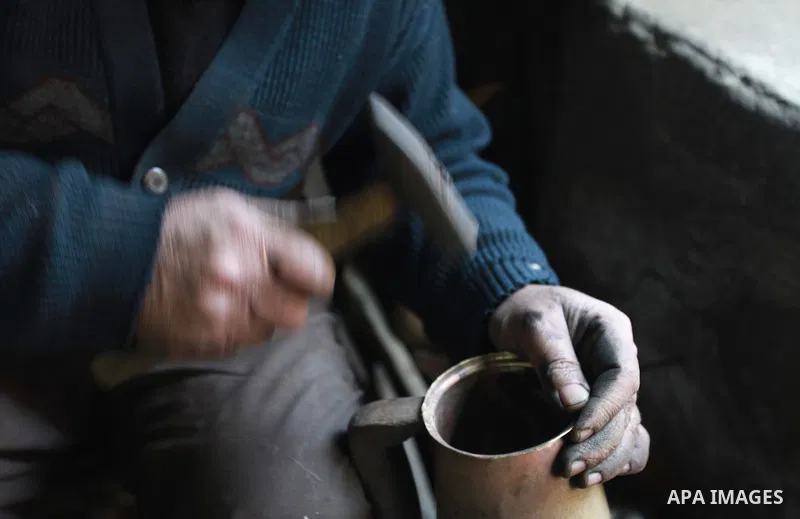 A Palestinian copper, Mohammed Abdo 56, works at his workshop, in Gaza city, on February 21, 2018. Abdo inherited copper profession from his father for nearly 40 years. Make replicas Crescent attached to mosques. He is t...