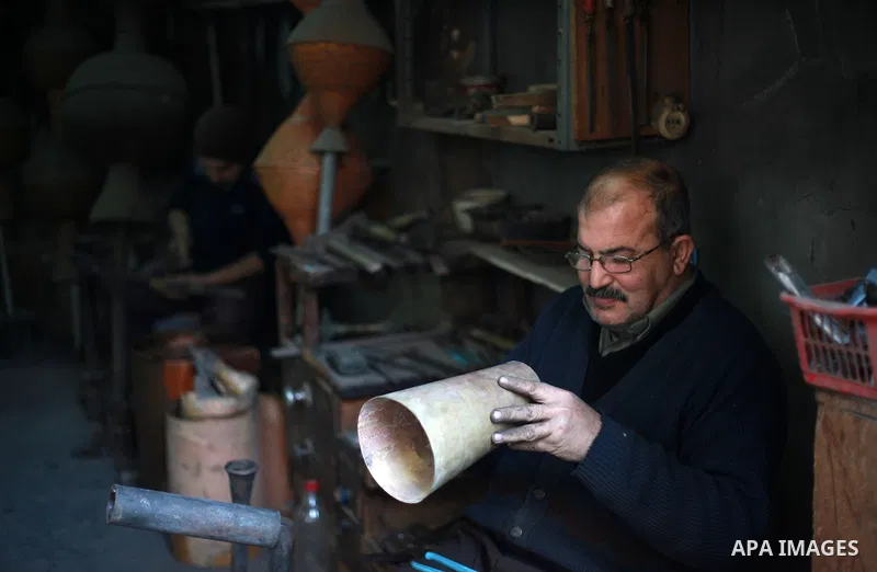 A Palestinian copper, Mohammed Abdo 56, works at his workshop, in Gaza city, on February 21, 2018. Abdo inherited copper profession from his father for nearly 40 years. Make replicas Crescent attached to mosques. He is t...