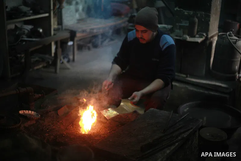 A Palestinian copper Ahmed Abdo, works at his father workshopt in Gaza city, on February 21, 2018. Abdo inherited copper profession from his father for nearly 40 years. Make replicas Crescent attached to mosques. He is t...