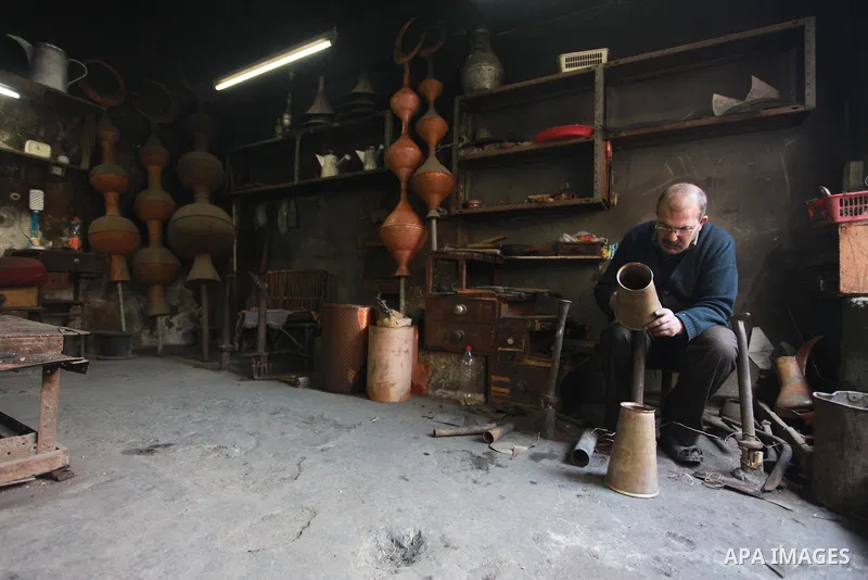 A Palestinian copper, Mohammed Abdo 56, works at his workshop, in Gaza city, on February 21, 2018. Abdo inherited copper profession from his father for nearly 40 years. Make replicas Crescent attached to mosques. He is t...