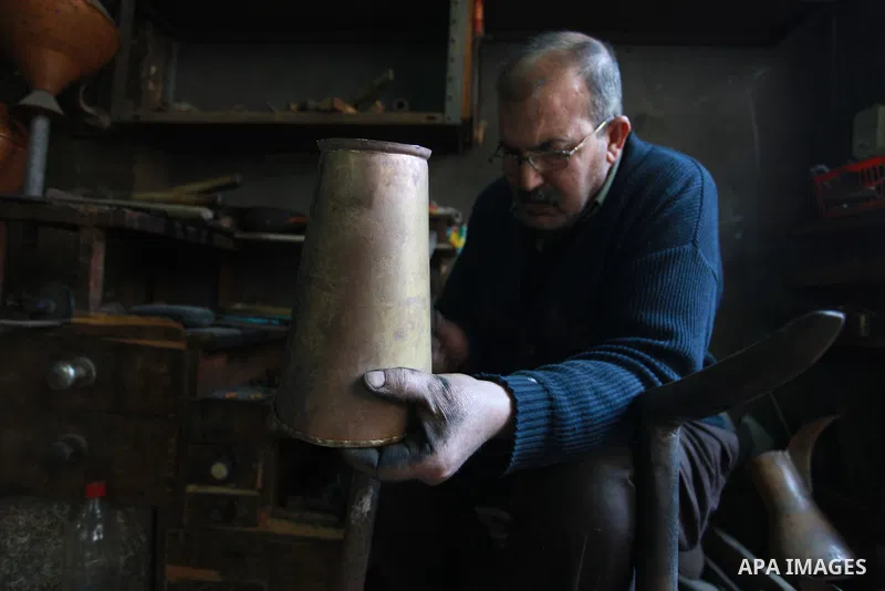 A Palestinian copper, Mohammed Abdo 56, works at his workshop, in Gaza city, on February 21, 2018. Abdo inherited copper profession from his father for nearly 40 years. Make replicas Crescent attached to mosques. He is t...