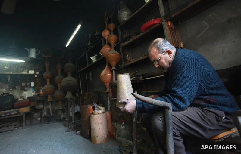 A Palestinian copper, Mohammed Abdo 56, works at his workshop, in Gaza city, on February 21, 2018. Abdo inherited copper profession from his father for nearly 40 years. Make replicas Crescent attached to mosques. He is t...