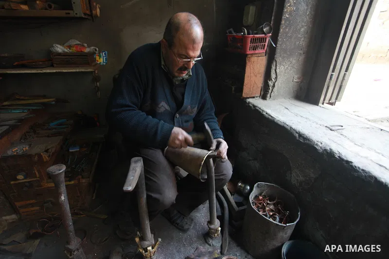 A Palestinian copper, Mohammed Abdo 56, works at his workshop, in Gaza city, on February 21, 2018. Abdo inherited copper profession from his father for nearly 40 years. Make replicas Crescent attached to mosques. He is t...